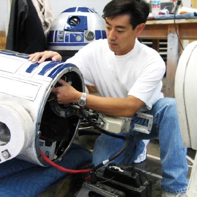 Grant Imahara works on an R2-D2 unit